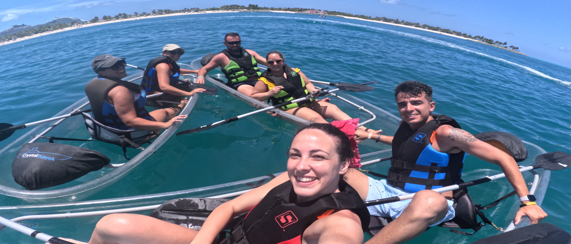 Kayaks de cristal con el grupo en aguas turquesa
